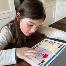 Child using Boom on a tablet.