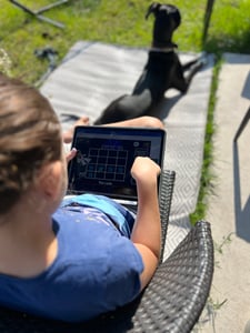 girl with boom cards and dog